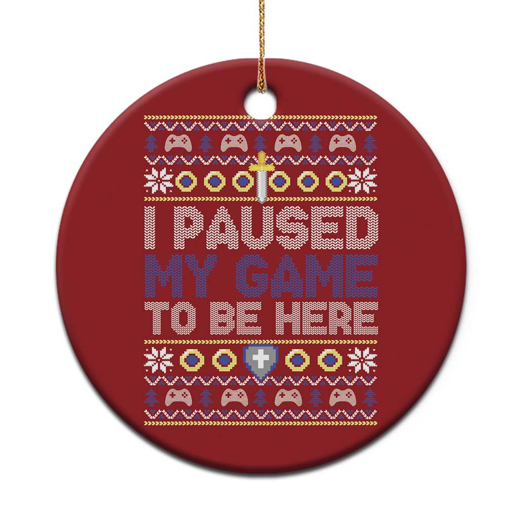Red round Christmas ornament with “I PAUSED MY GAME TO BE HERE” text and gold loop.