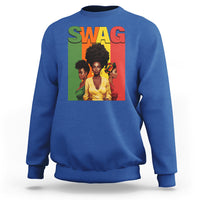 Blue crewneck sweatshirt with multicolor “SWAG” graphic and portrait artwork