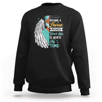 Black sweatshirt with nurse quote graphic and angel wing print on front.