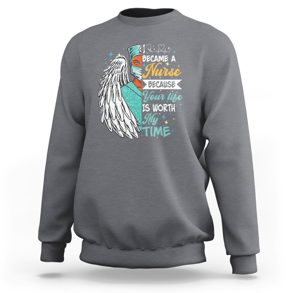 Charcoal sweatshirt with nurse quote graphic and angel wing print on front.