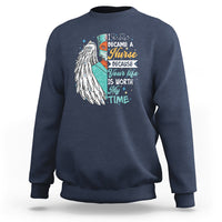 Navy sweatshirt with nurse quote graphic and angel wing print on front.