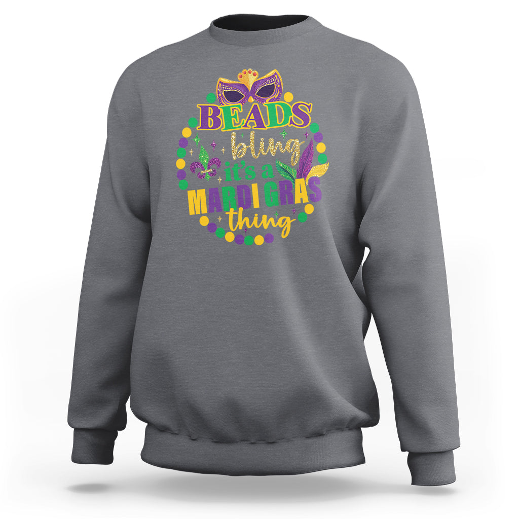 Charcoal gray crewneck sweatshirt with multicolor “Beads bling” Mardi Gras graphic on front.