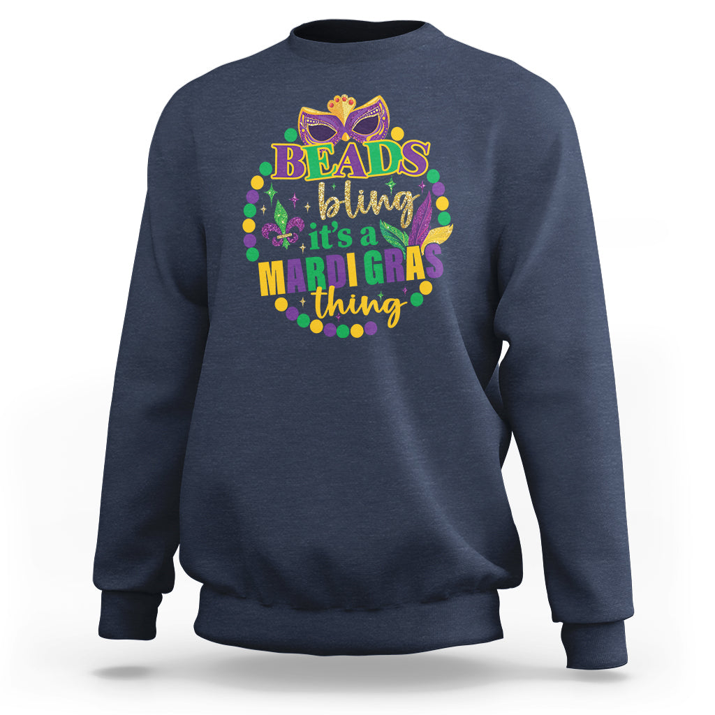 Navy crewneck sweatshirt with multicolor “Beads bling” Mardi Gras graphic on front.