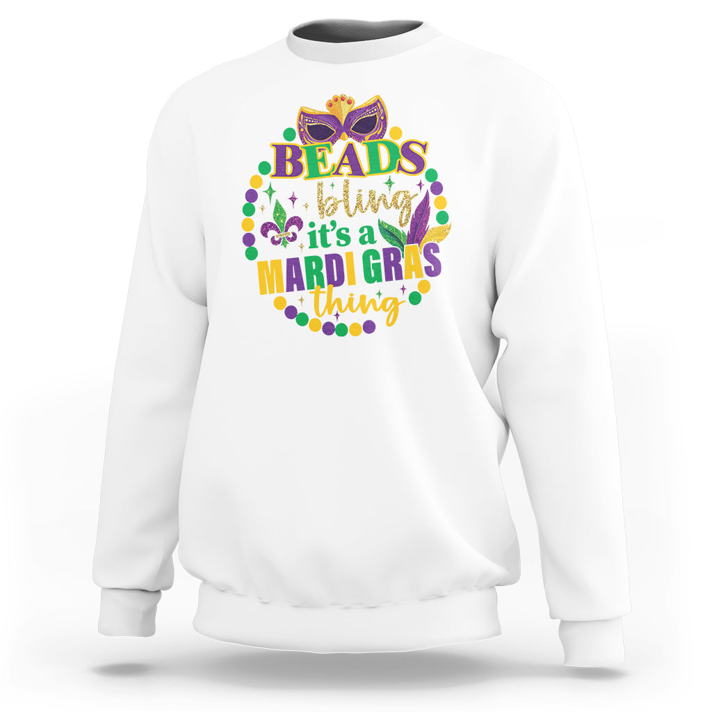 White crewneck sweatshirt with multicolor “Beads bling” Mardi Gras graphic on front.