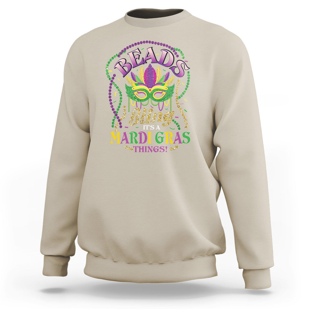Sand/beige sweatshirt with colorful Mardi Gras mask and bead-style graphic on chest