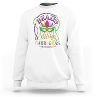 White sweatshirt with colorful Mardi Gras mask and bead-style graphic on chest