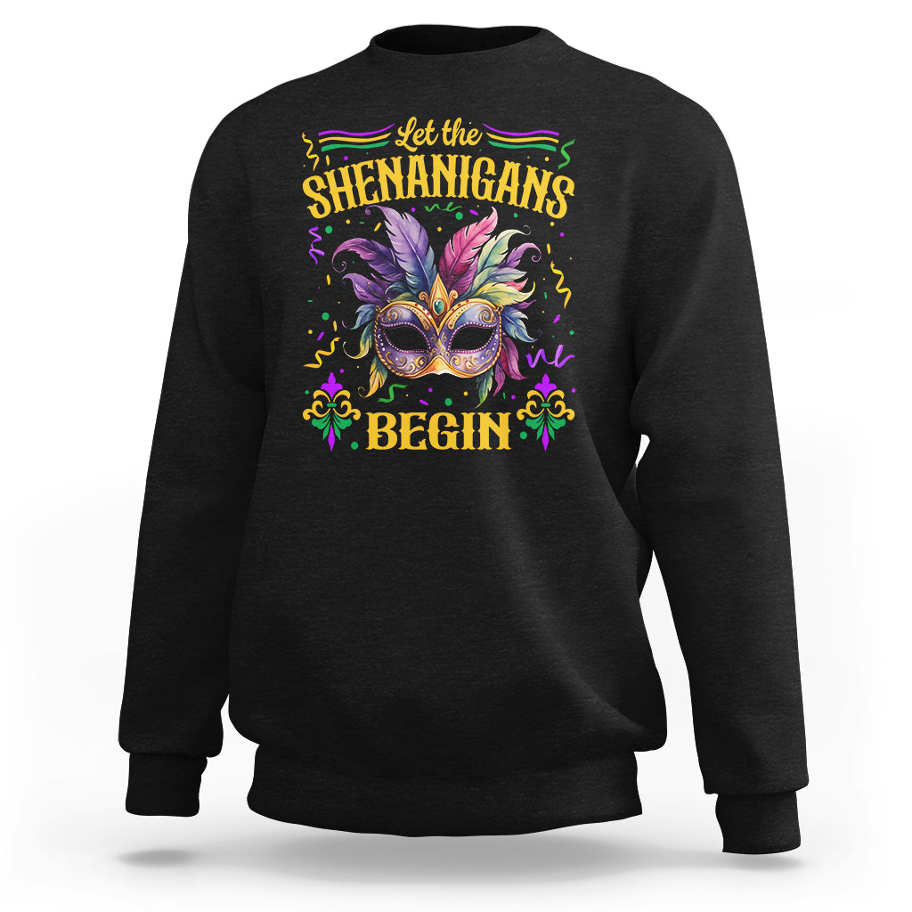Black Mardi Gras sweatshirt with masquerade mask graphic and 'Shenanigans Begin'.