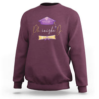 Maroon crewneck PhD graduation sweatshirt with long sleeves and purple cap back graphic