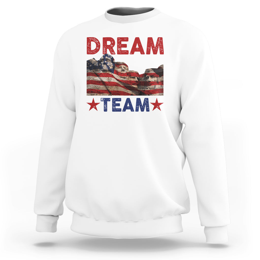 White crewneck sweatshirt with 'DREAM TEAM' graphic and star accents