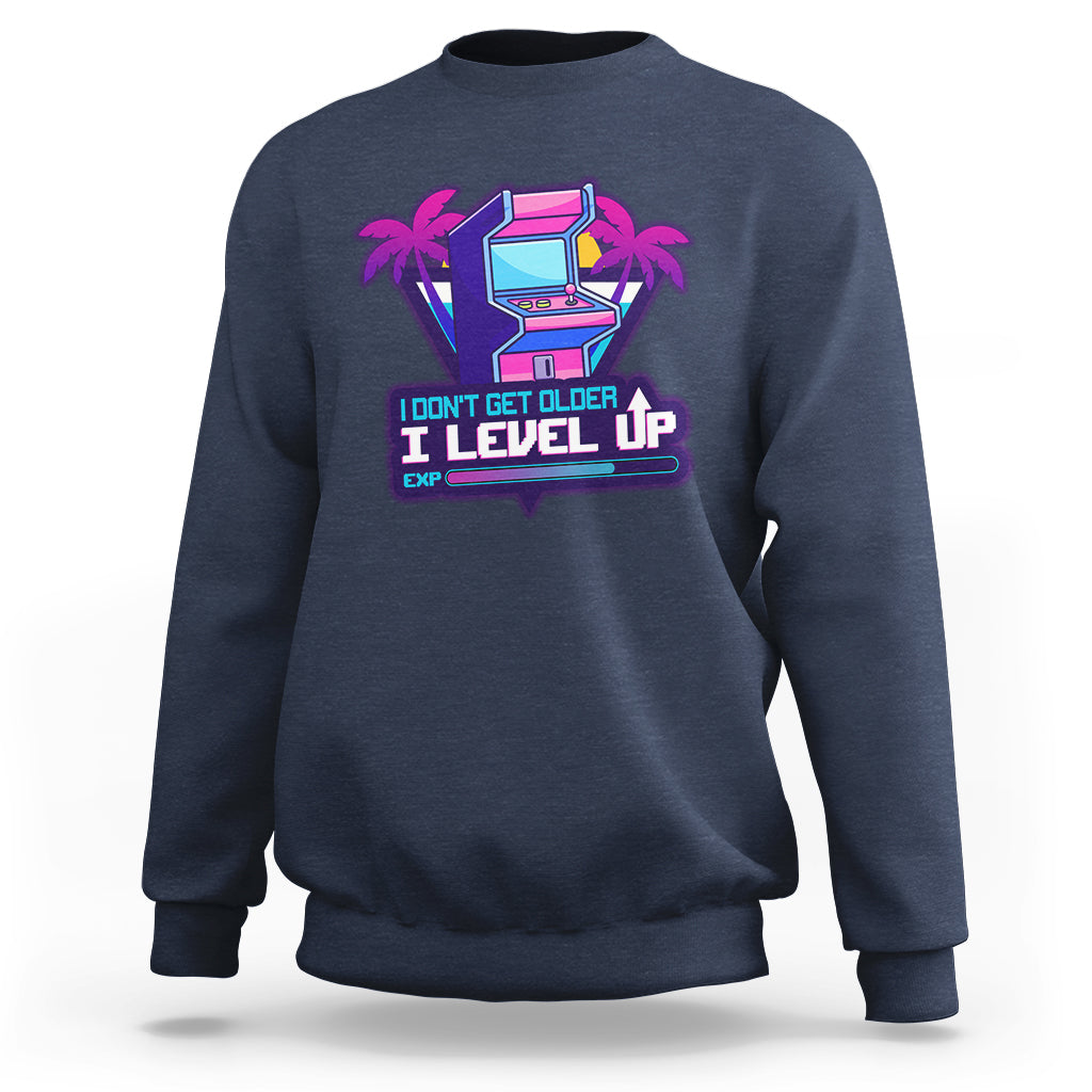 Navy crewneck sweatshirt with colorful gaming console graphic and Level Up slogan