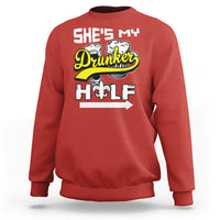 Red sweatshirt with “She's My Drunker” and illustrated fleur-de-lis text graphic