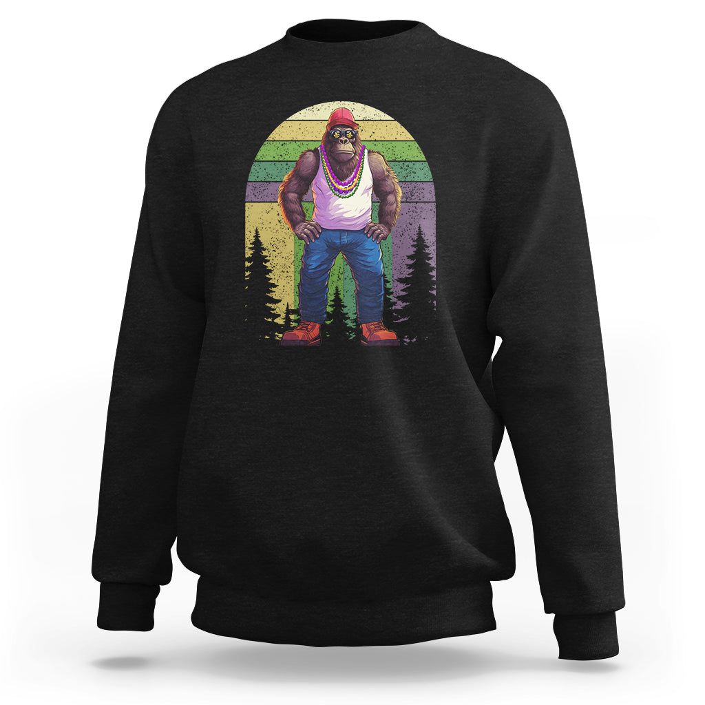 Black crewneck sweatshirt with Bigfoot in Mardi Gras colors and forest graphic on front.