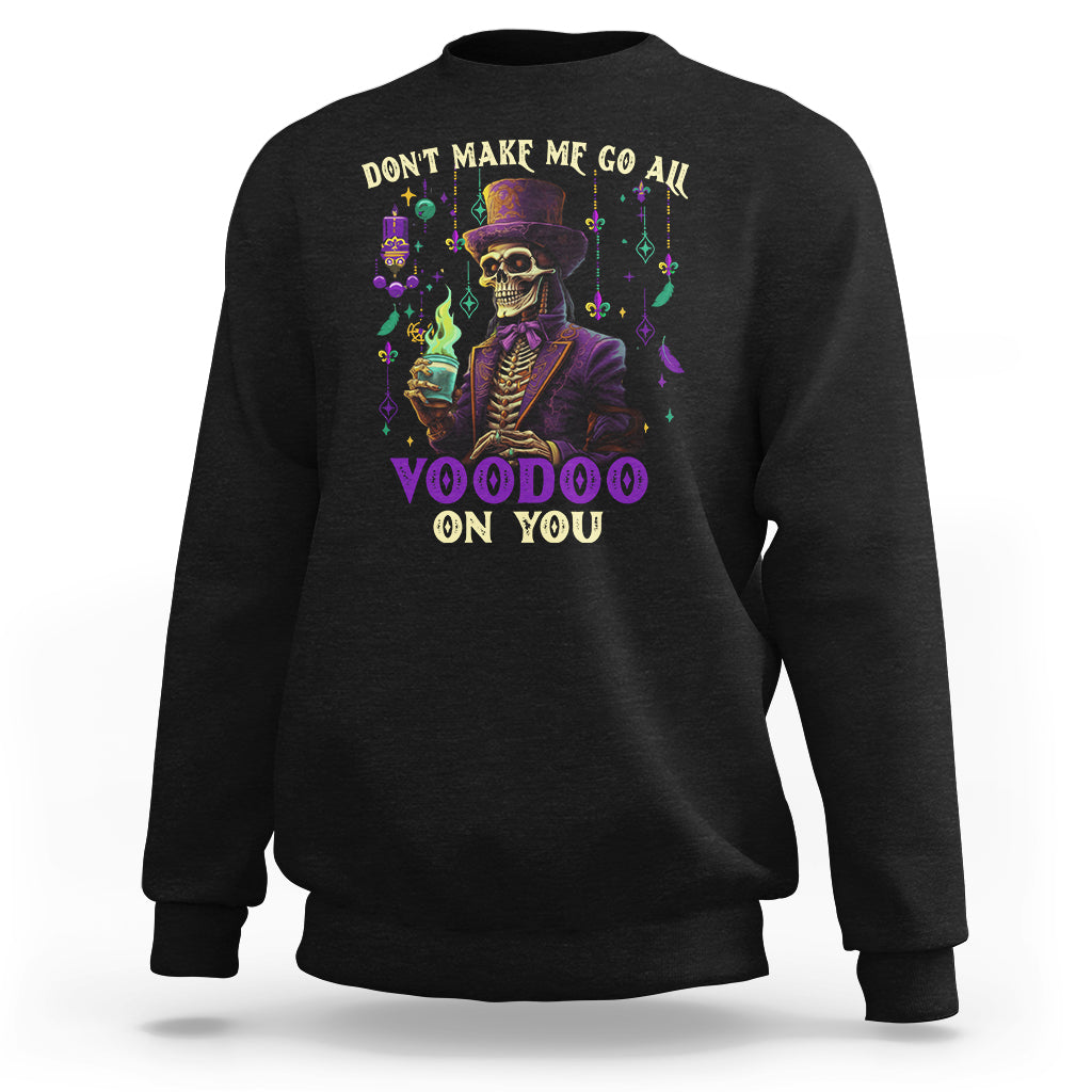 Black sweatshirt with colorful witch doctor skeleton graphic and “Voodoo on you” text