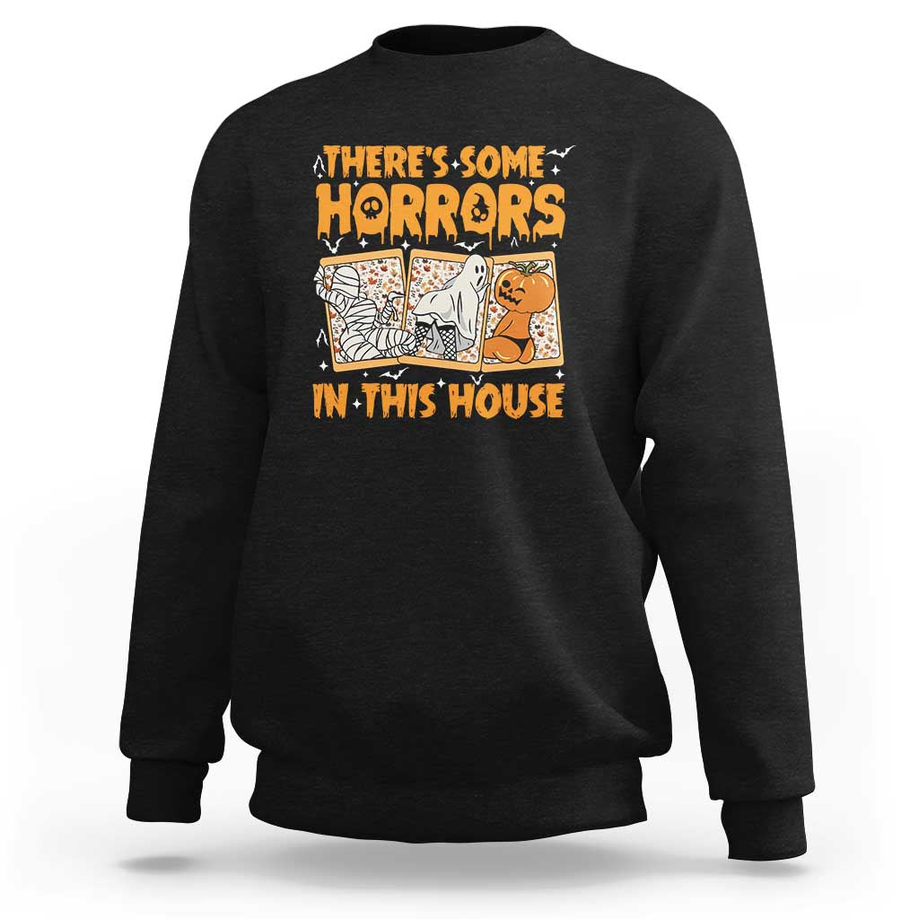 Funny Halloween sweatshirt in black, with “There’s Some Horrors In This House” graphic.