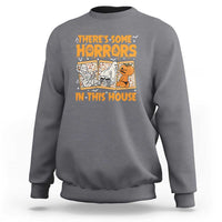 Funny Halloween sweatshirt in charcoal gray, with “There’s Some Horrors In This House” graphic.