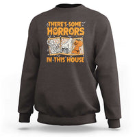 Funny Halloween sweatshirt in dark chocolate brown, with “There’s Some Horrors In This House” graphic.
