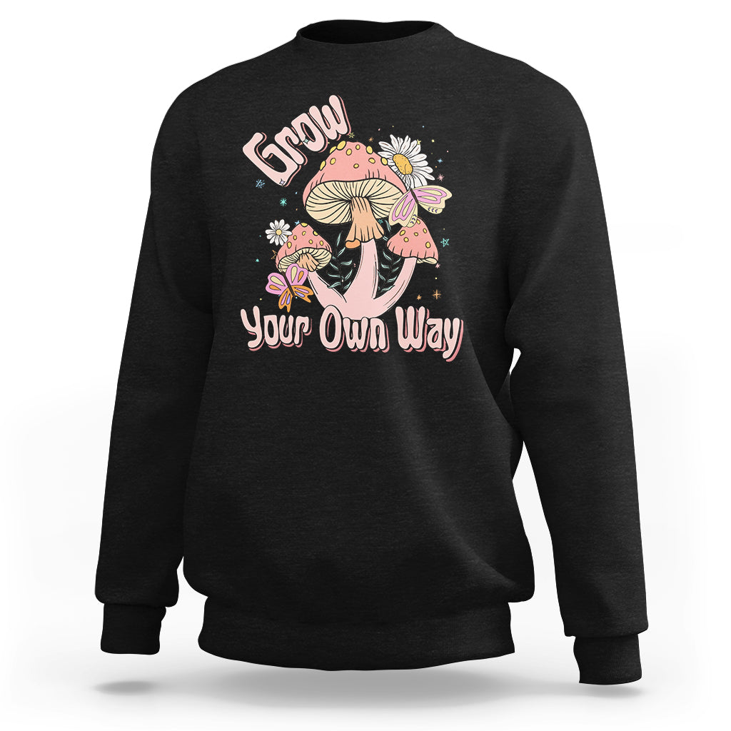 Black crewneck sweatshirt with "Grow Your Own Way" mushroom graphic on front