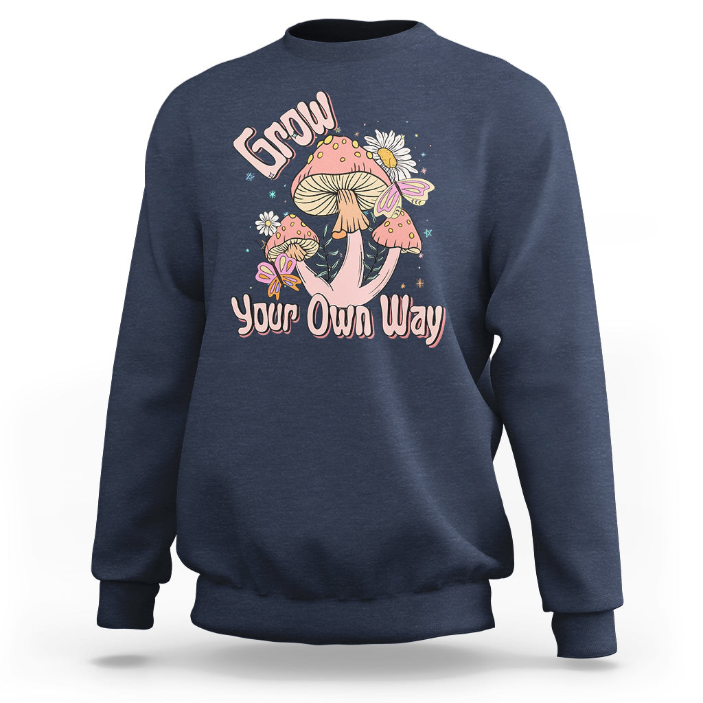 Navy crewneck sweatshirt with "Grow Your Own Way" mushroom graphic on front