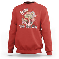 Red crewneck sweatshirt with "Grow Your Own Way" mushroom graphic on front