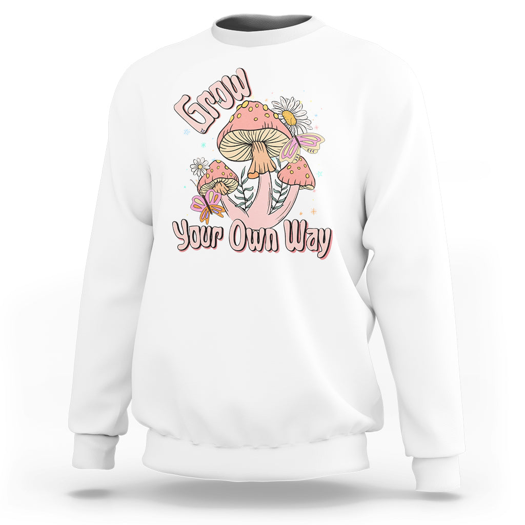White crewneck sweatshirt with "Grow Your Own Way" mushroom graphic on front