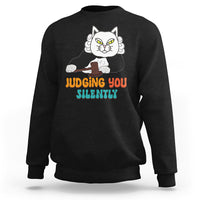 Black sweatshirt with cat graphic and “JUDGING YOU” “SILENTLY” text on front.