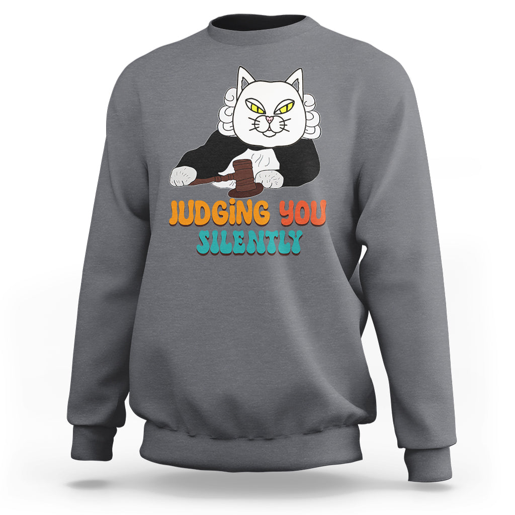 Charcoal gray sweatshirt with cat graphic and “JUDGING YOU” “SILENTLY” text on front.