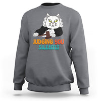 Charcoal gray sweatshirt with cat graphic and “JUDGING YOU” “SILENTLY” text on front.
