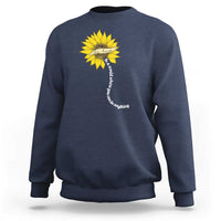 Navy sweatshirt with yellow sunflower graphic and motivational vertical text on back