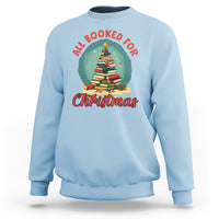 Light blue Christmas sweatshirt with 'All Booked For Christmas' book tree graphic
