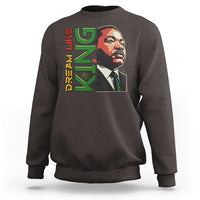 Dark chocolate crewneck sweatshirt with MLK portrait and DREAM graphic print.