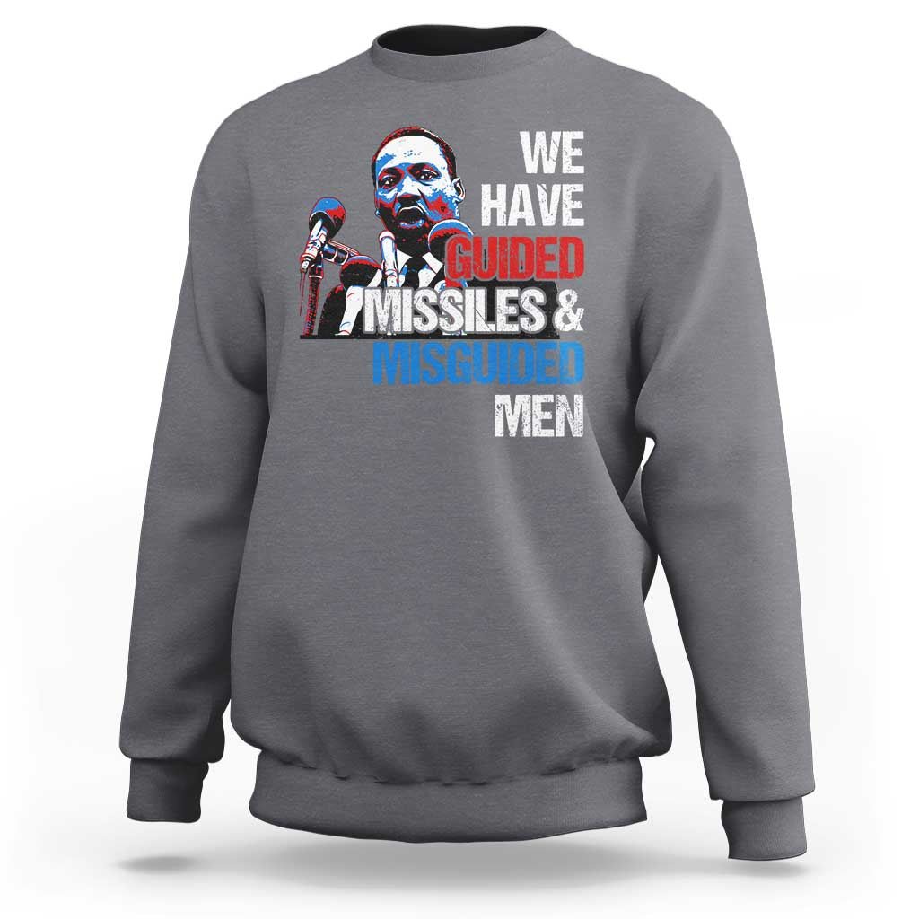 Charcoal gray crewneck sweatshirt with large front graphic text: “WE HAVE GUIDED MISSILES & MISGUIDED MEN”.