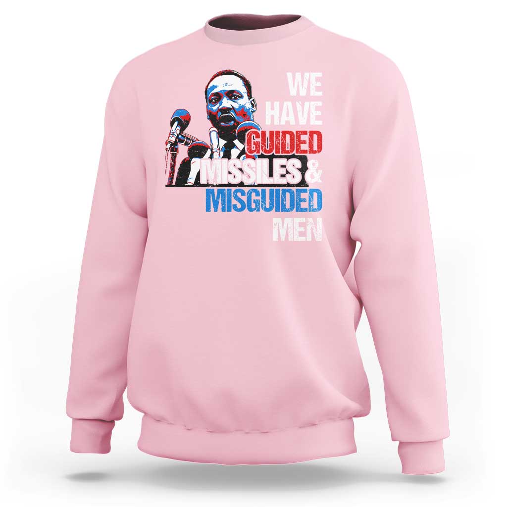 Light pink crewneck sweatshirt with large front graphic text: “WE HAVE GUIDED MISSILES & MISGUIDED MEN”.