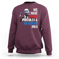 Maroon crewneck sweatshirt with large front graphic text: “WE HAVE GUIDED MISSILES & MISGUIDED MEN”.