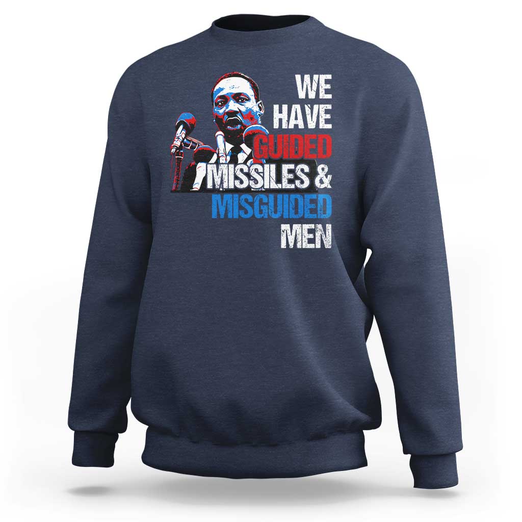 Navy crewneck sweatshirt with large front graphic text: “WE HAVE GUIDED MISSILES & MISGUIDED MEN”.