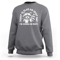 Charcoal raccoon graphic sweatshirt with bold text design and crew neck