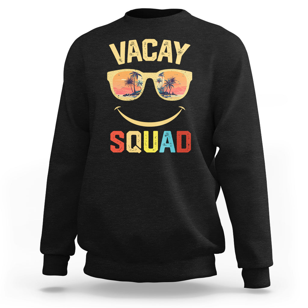 Black crewneck sweatshirt with front graphic text "VACAY SQUAD" and sunglasses smile.