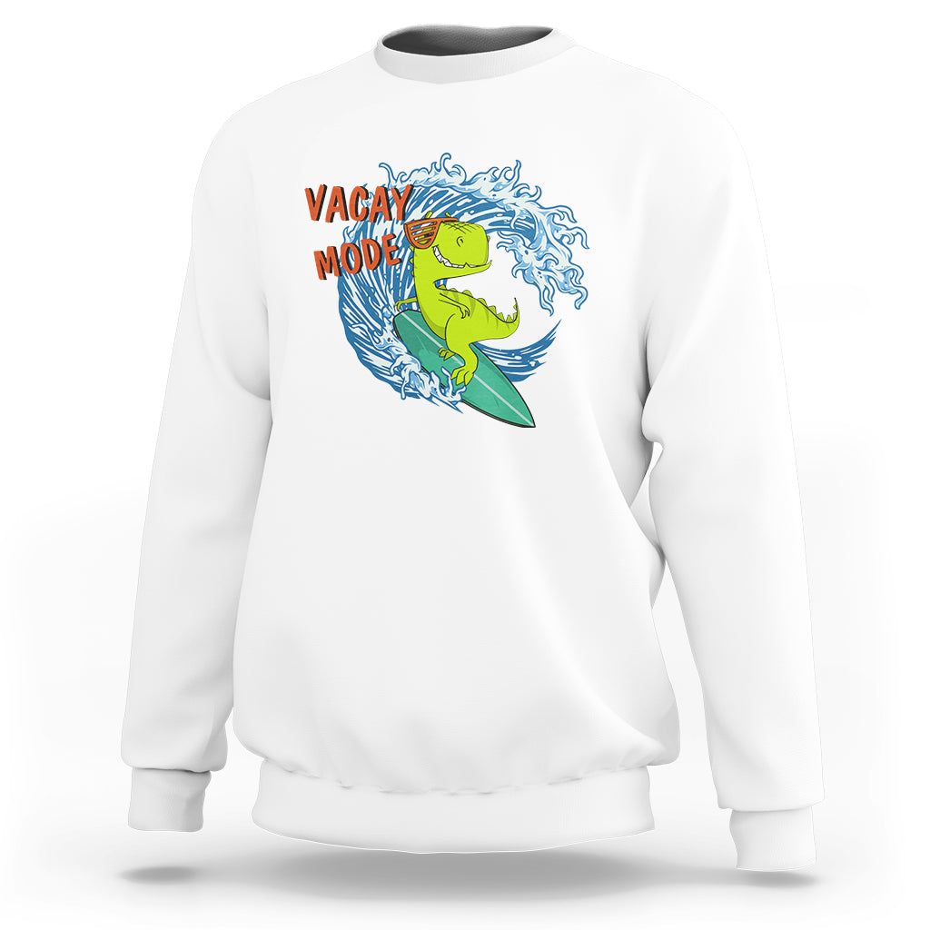 White sweatshirt with "Vacay Mode" dinosaur surfing graphic