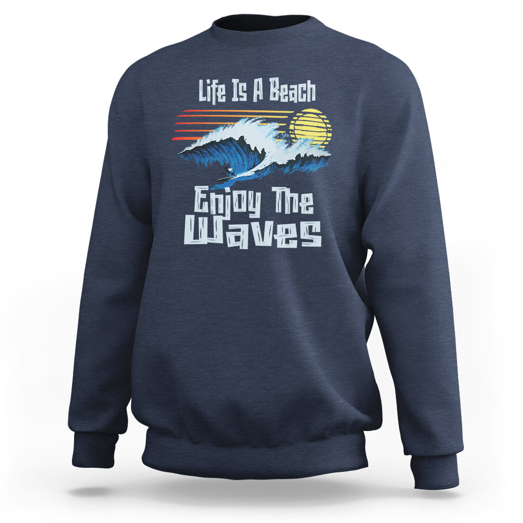 Navy crewneck sweatshirt with beach wave graphic and “Enjoy The Waves” text