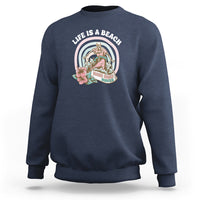 Navy sweatshirt with round beach graphic on the chest, crew neck and long sleeves