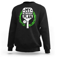 Black crewneck sweatshirt with green pickleball retirement graphic on chest.