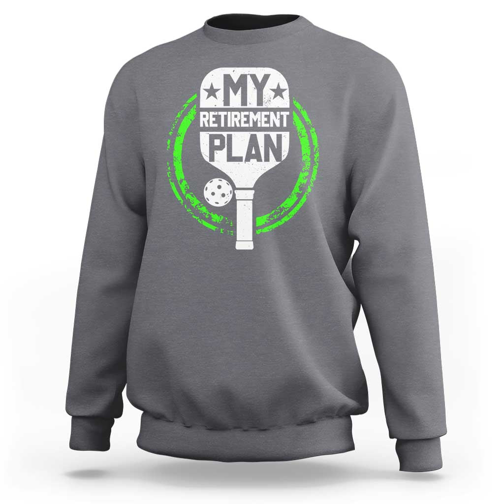 Charcoal heather crewneck sweatshirt with green pickleball retirement graphic on chest.