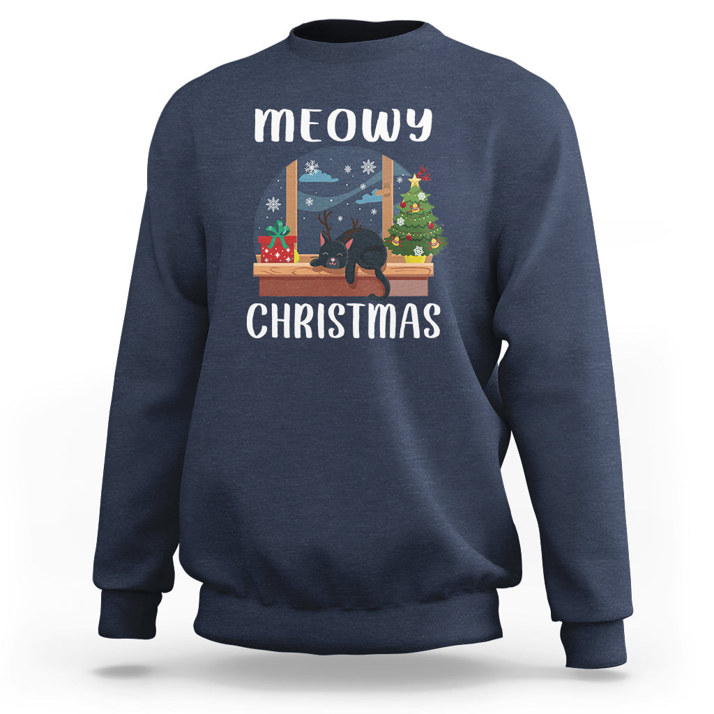 Navy crewneck sweatshirt with “meowy CHRISTMAS” cat window graphic on front.