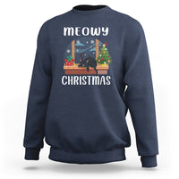 Navy crewneck sweatshirt with “meowy CHRISTMAS” cat window graphic on front.