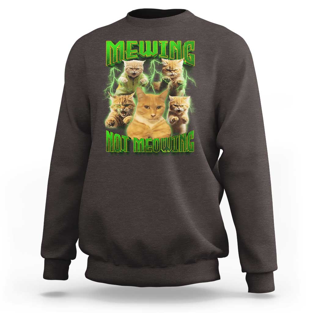 Dark chocolate brown sweatshirt with cat meme graphic reading 'MEWING NOT MEOWING' in neon green