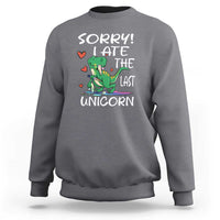 Charcoal gray sweatshirt with green dinosaur graphic and 'SORRY! EAT THE LAST UNICORN' text