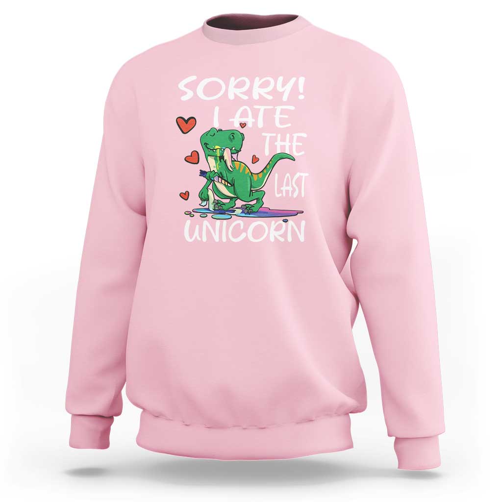 Light pink sweatshirt with green dinosaur graphic and 'SORRY! EAT THE LAST UNICORN' text