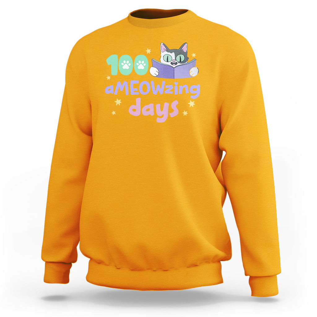 Gold sweatshirt with "aMEOWzing days" cat reading book graphic