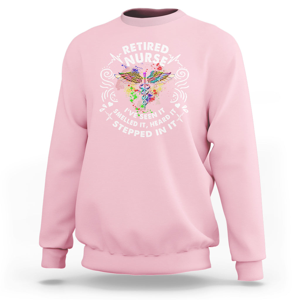 Light pink retired nurse crewneck sweatshirt with colorful nurse graphic and slogan