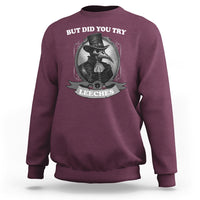 Maroon plague doctor sweatshirt with 'BUT DID YOU TRY' leeches chest graphic