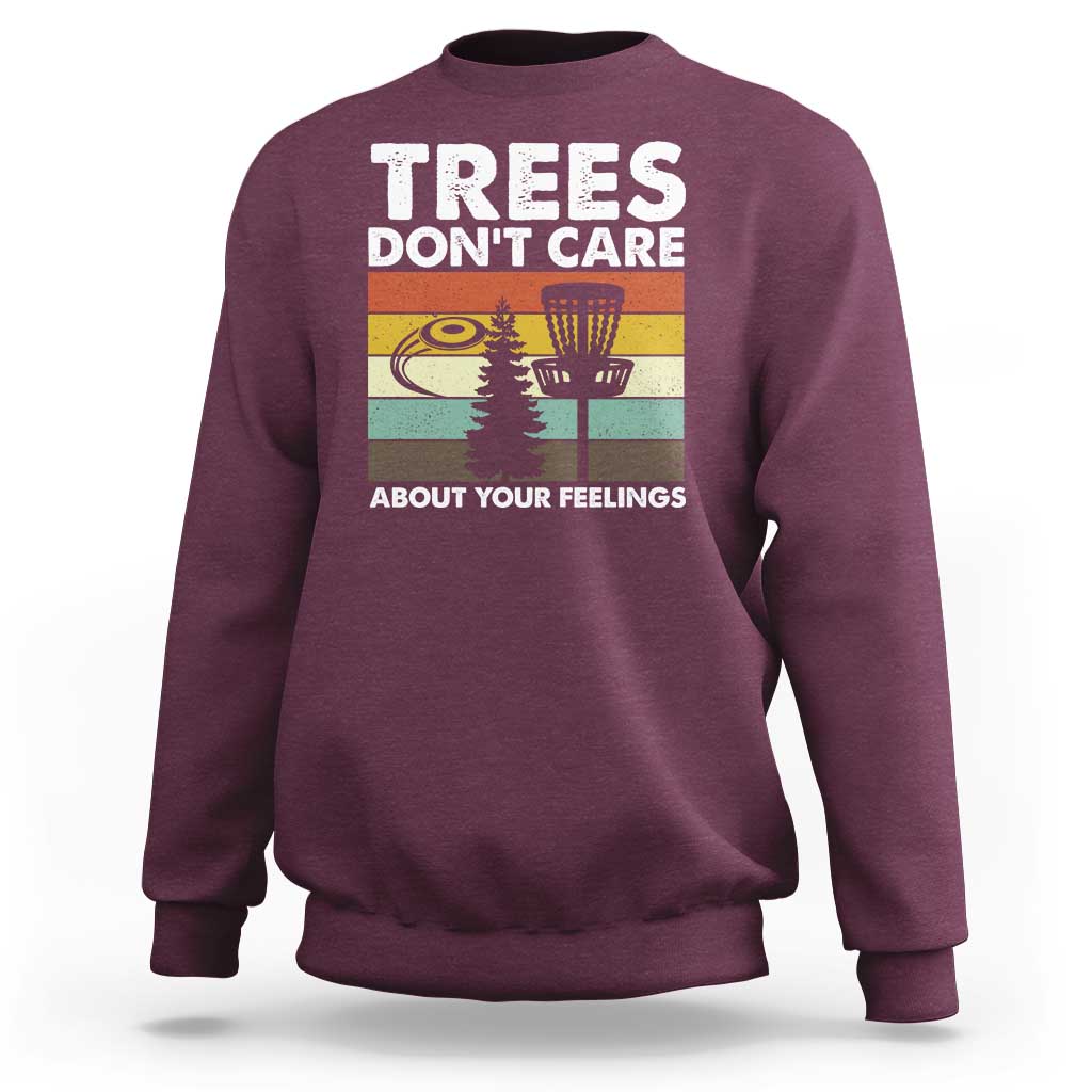 Maroon crewneck sweatshirt with “Trees don’t care” graphic and trees scene.